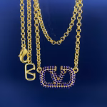 Valentino's new blue colored diamond-encrusted letter V personalized necklace